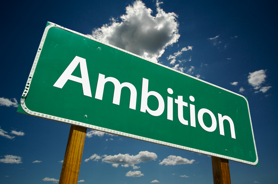 Ambition Green Road Sign Over Dramatic Sky and Clouds.